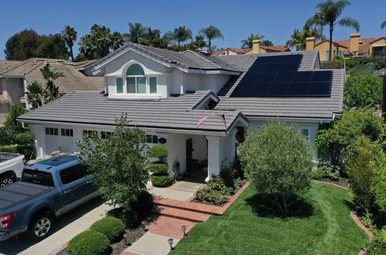 Technicians installing solar panels on a residential rooftop.